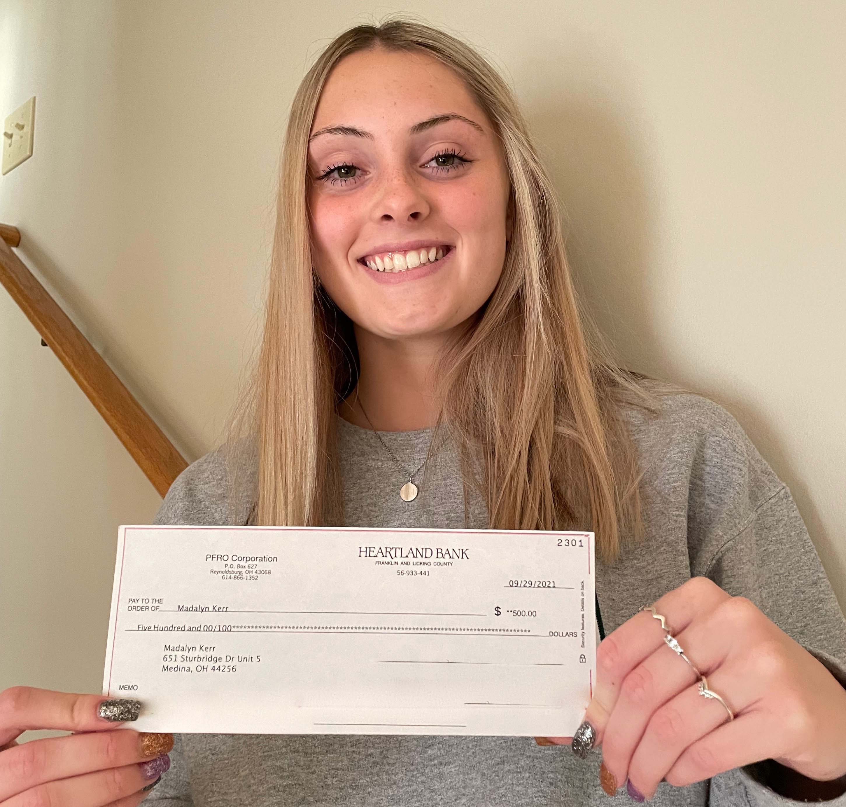 Madalyn Kerr with her check